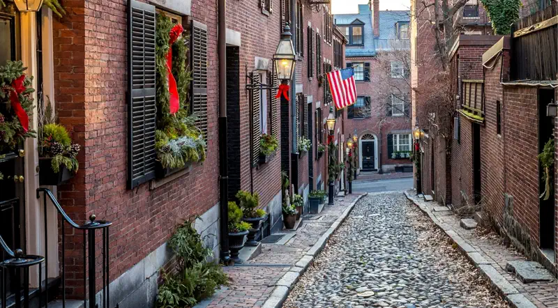 A Beacon Hill brick lane in winter with wreaths and bare trees