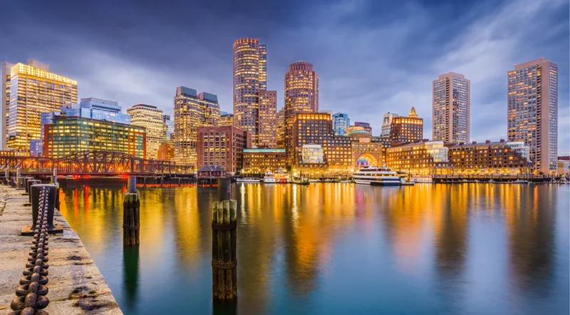 Boston waterfront skyline reflected in the harbor at night